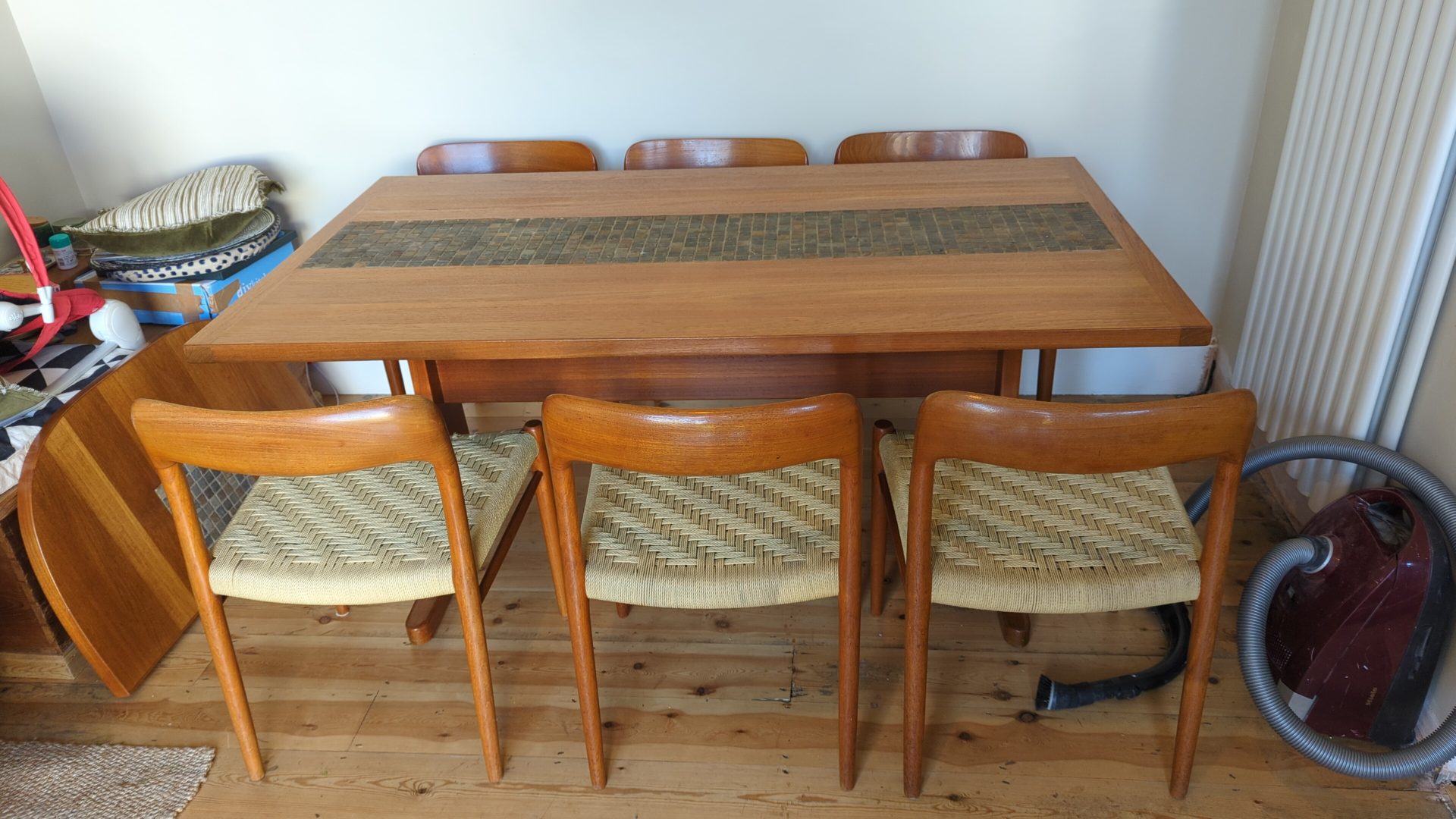 Mid-century teak dining table with slate tile inlay and six woven-seat chairs after restoration