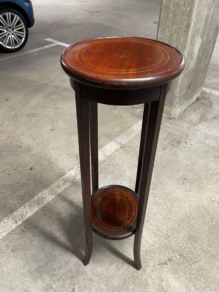 Antique mahogany tall plant stand with round inlaid top and lower shelf on sabre legs